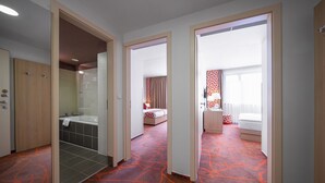 A hotel room with a bathroom, a bed, and a sitting area. - Iris Hotel Eden - Czech Leading Hotels (Prague)