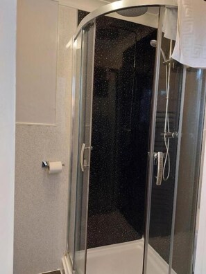 Enjoy a refreshing shower experience with a clear view and convenient amenities.