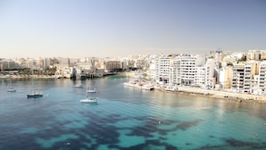 A coastal cityscape with a marina, boats, and high-rise buildings. - Cavalieri Hotel Malta, a member of Radisson Individuals (St. Julian's)