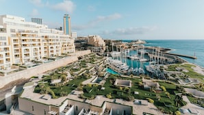 A resort with multiple swimming pools, a marina with boats, and a large hotel building. - Cavalieri Hotel Malta, a member of Radisson Individuals (St. Julian's)