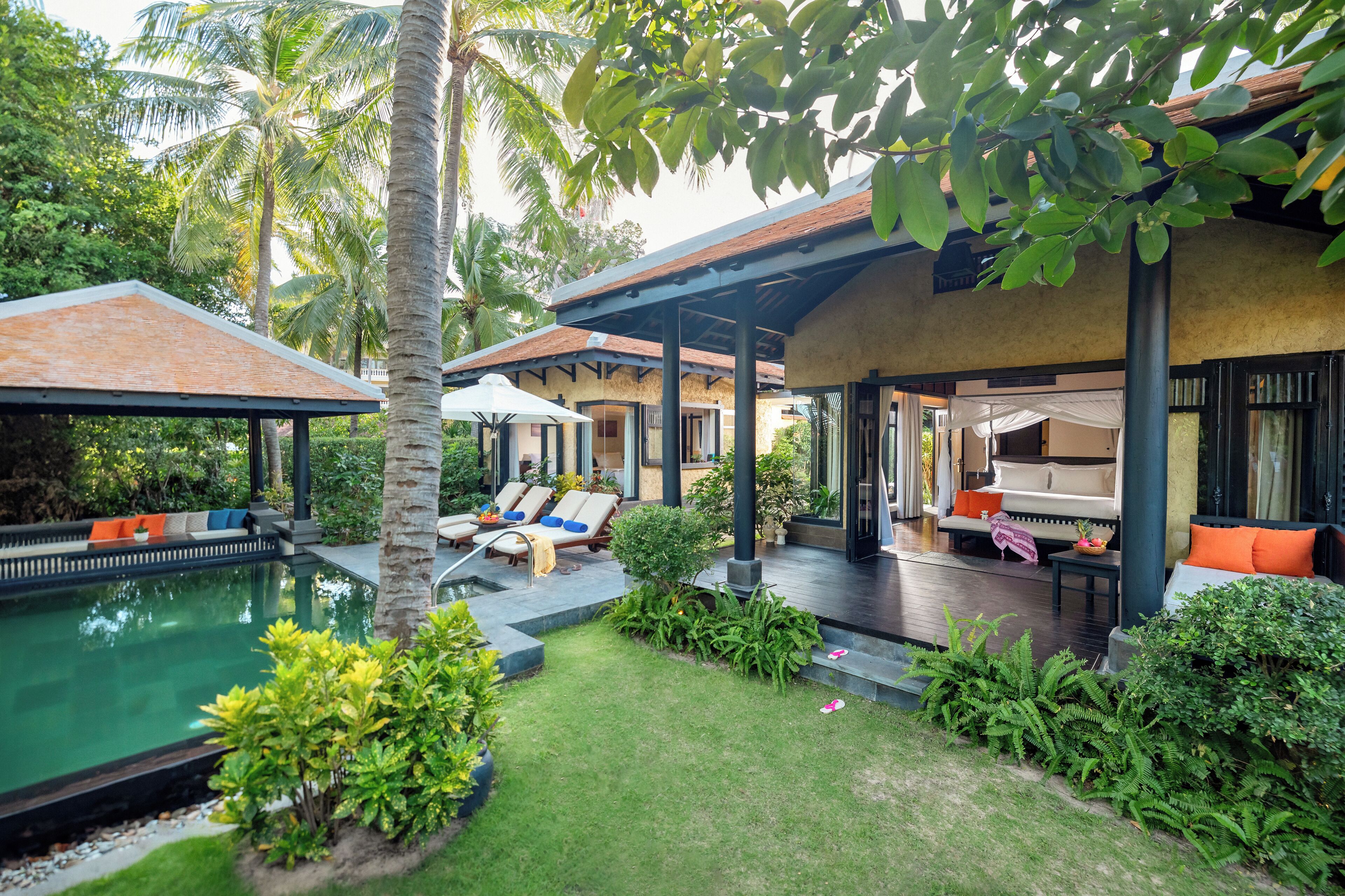 A poolside area with lounge chairs and a covered seating area.