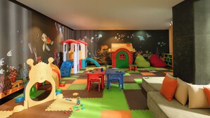 A children's playroom with a slide, playhouse, and various toys. - Anantara Mui Ne Resort (Mui Ne)