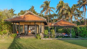 A two-story building with a wooden roof and a covered patio area. - Anantara Mui Ne Resort (Mui Ne)