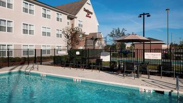 Relax by the pool with lounge chairs and umbrellas.