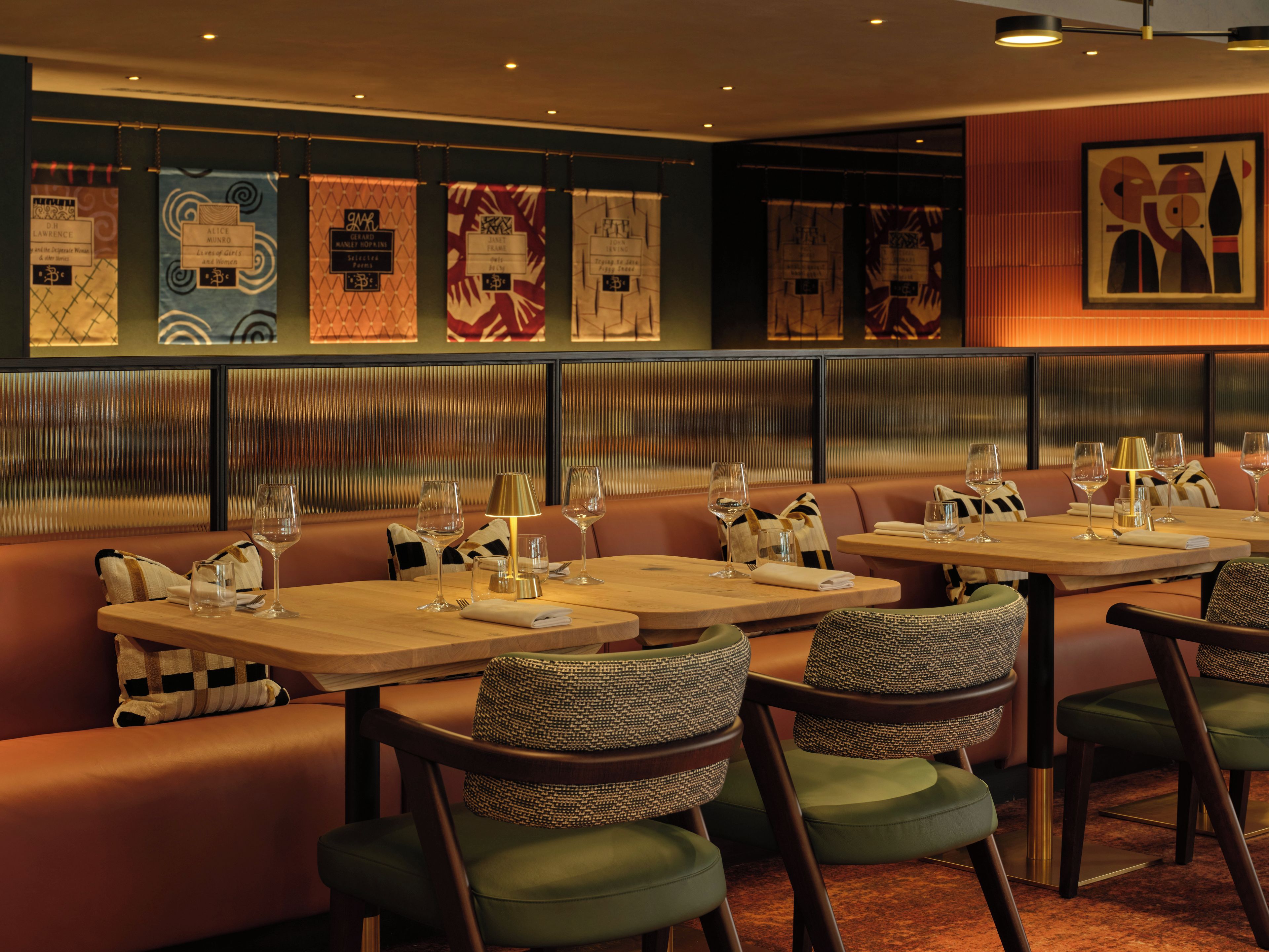 A restaurant interior with booths, tables, and wall decorations.
