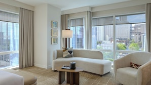A hotel room with a sofa, armchair, and a small table with a lamp. - JW Marriott Atlanta Downtown (Atlanta)