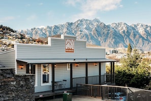 A building with a sign reading "DAIRY THE PRIVATE LIVING HOTEL" with a mountainous backdrop. - The Dairy Hotel Queenstown, A Naumi Chapter (Queenstown)