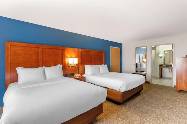 Premium bedding, desk, laptop workspace, blackout drapes