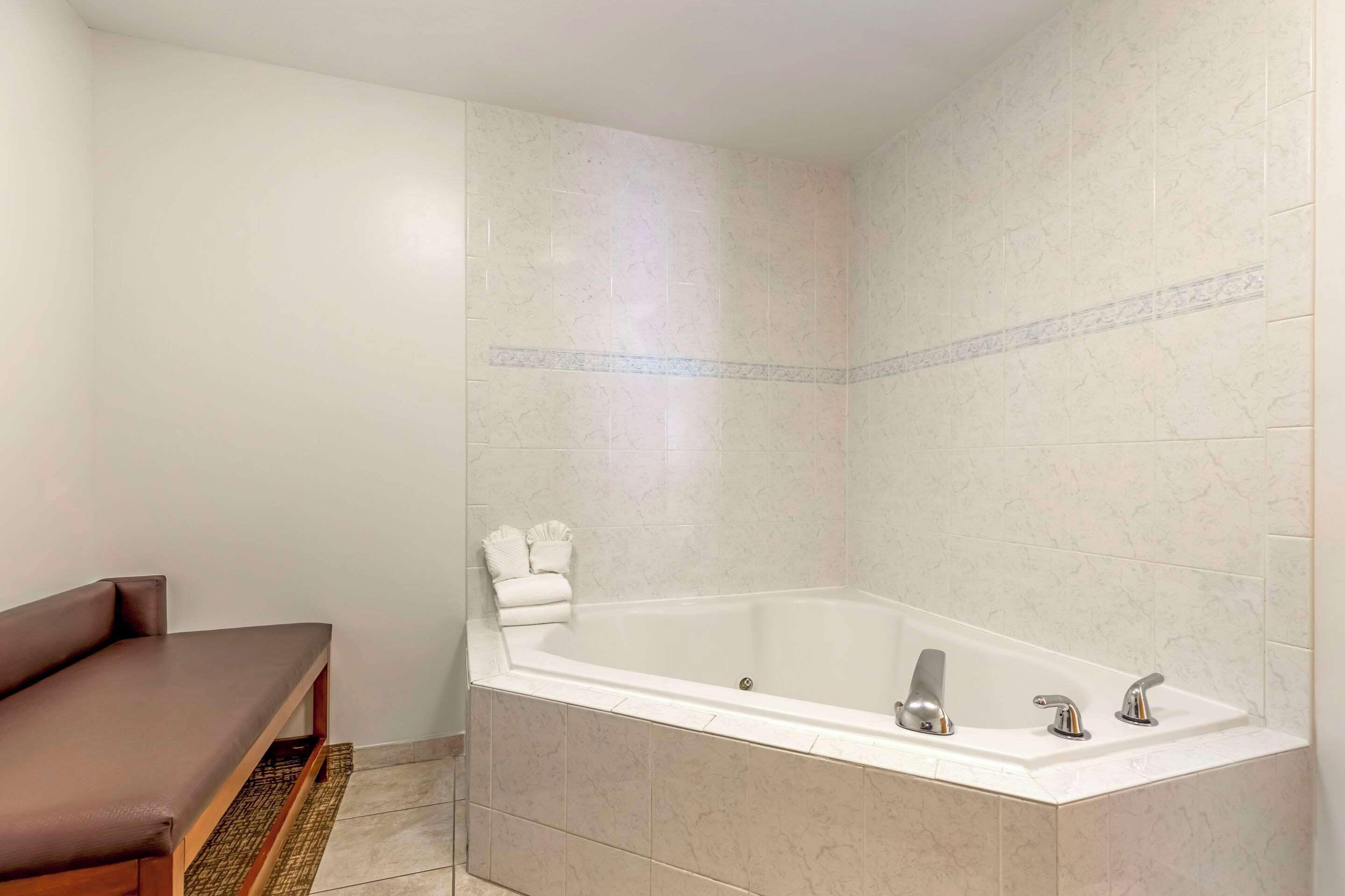 business suite, 1 king bed with sofa bed and hot tub, non smoking | premium bedding, desk, laptop workspace, blackout curtains