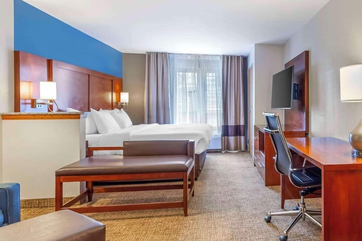 Premium bedding, desk, laptop workspace, blackout curtains