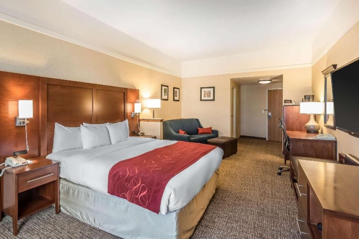 Premium bedding, desk, laptop workspace, blackout drapes