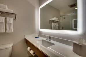 A bathroom with a large mirror, a sink, and a towel rack. - Holiday Inn Express Lexington North-Georgetown by IHG (Georgetown)