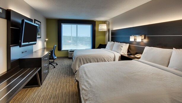 A hotel room with two beds, a desk with a flat-screen TV, a chair, and a large window offering a view of a bridge. - Holiday Inn Express Lexington North-Georgetown by IHG (Georgetown)
