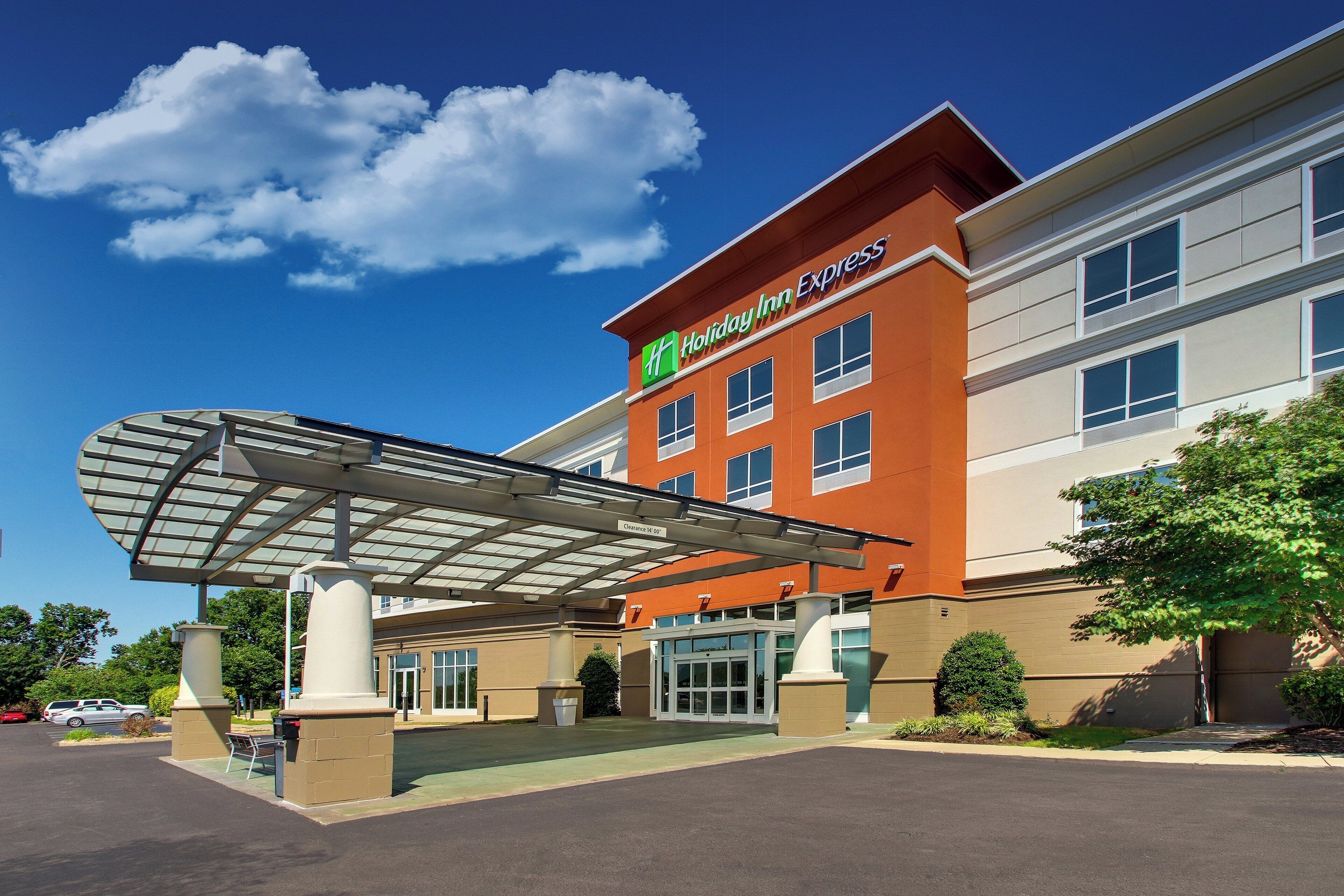 A Holiday Inn Express hotel with a covered entrance and a clear sky.