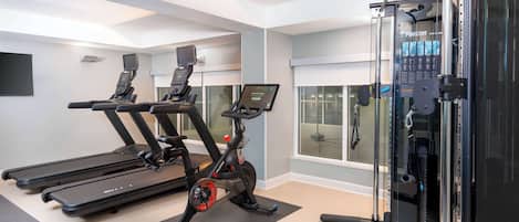A gym with treadmills, an exercise bike, and a weight machine.