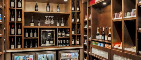 A wine and beverage section with shelves of wine bottles, a refrigerated display case, and a 'Welcome to Windsor' sign.