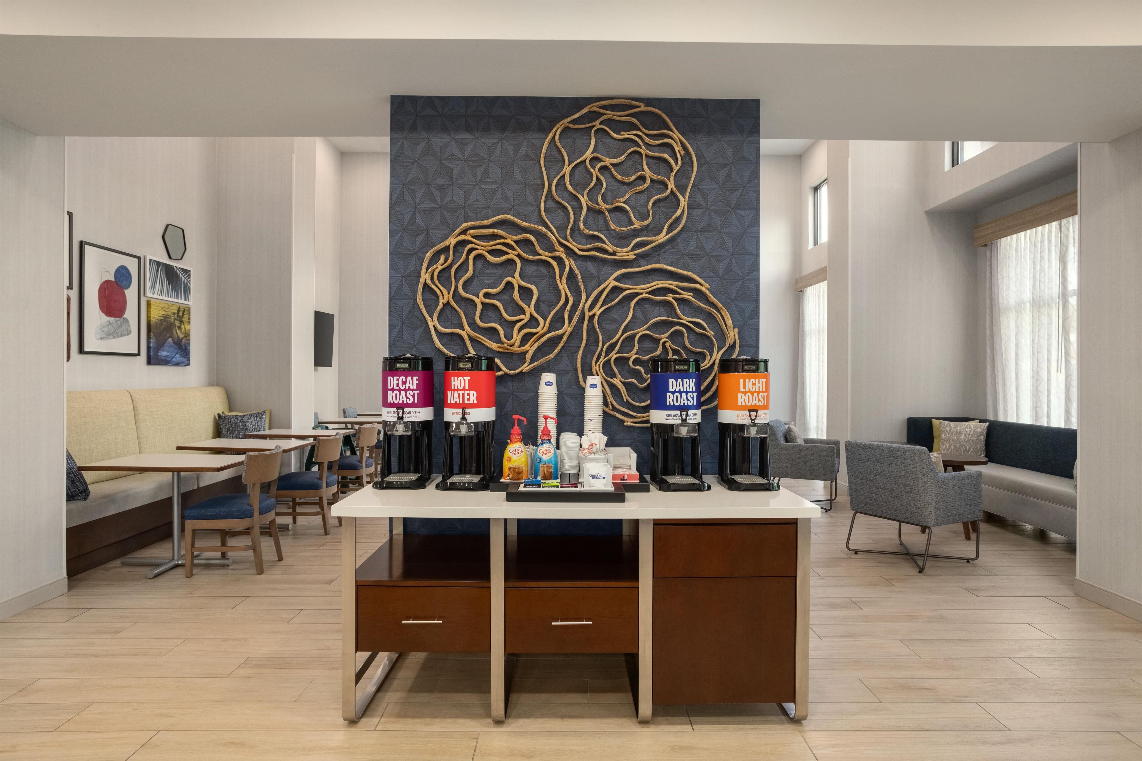 A modern coffee bar with multiple coffee dispensers labeled with different types of coffee.