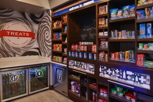 A self-service snack and sundries kiosk with a variety of packaged snacks and drinks.