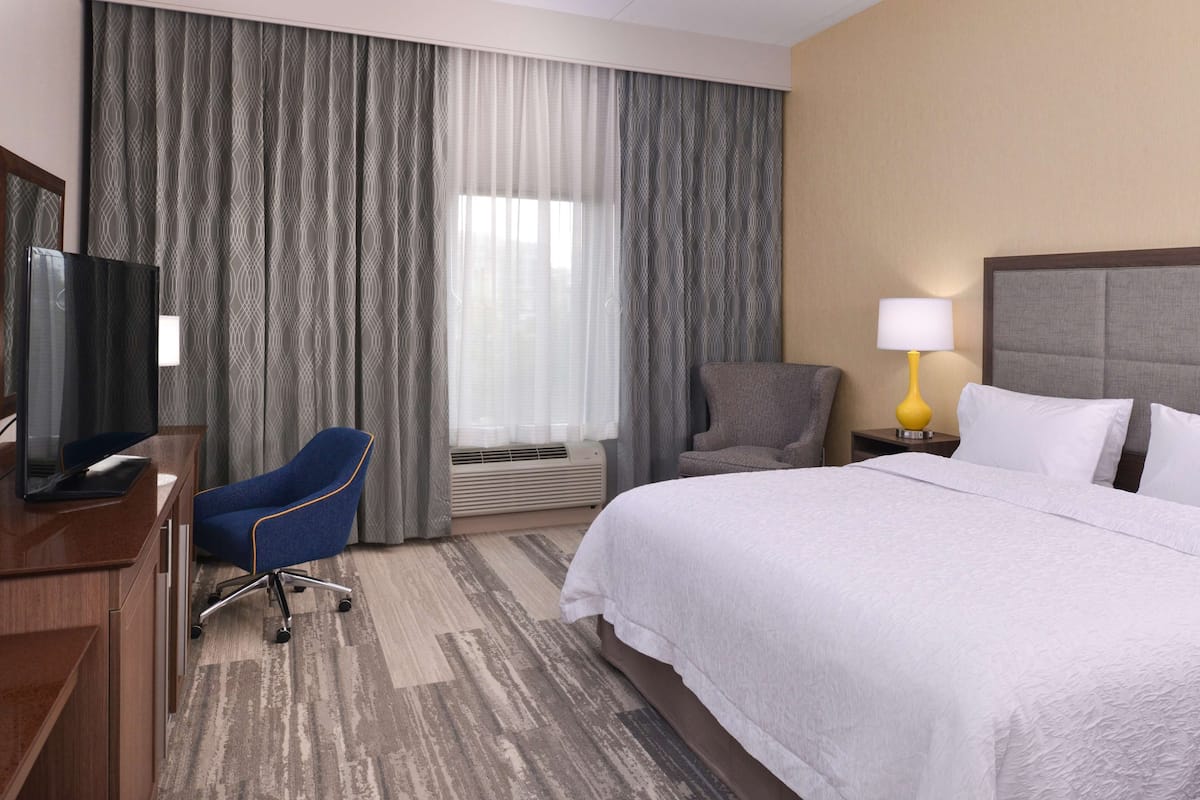 Premium bedding, desk, laptop workspace, blackout curtains