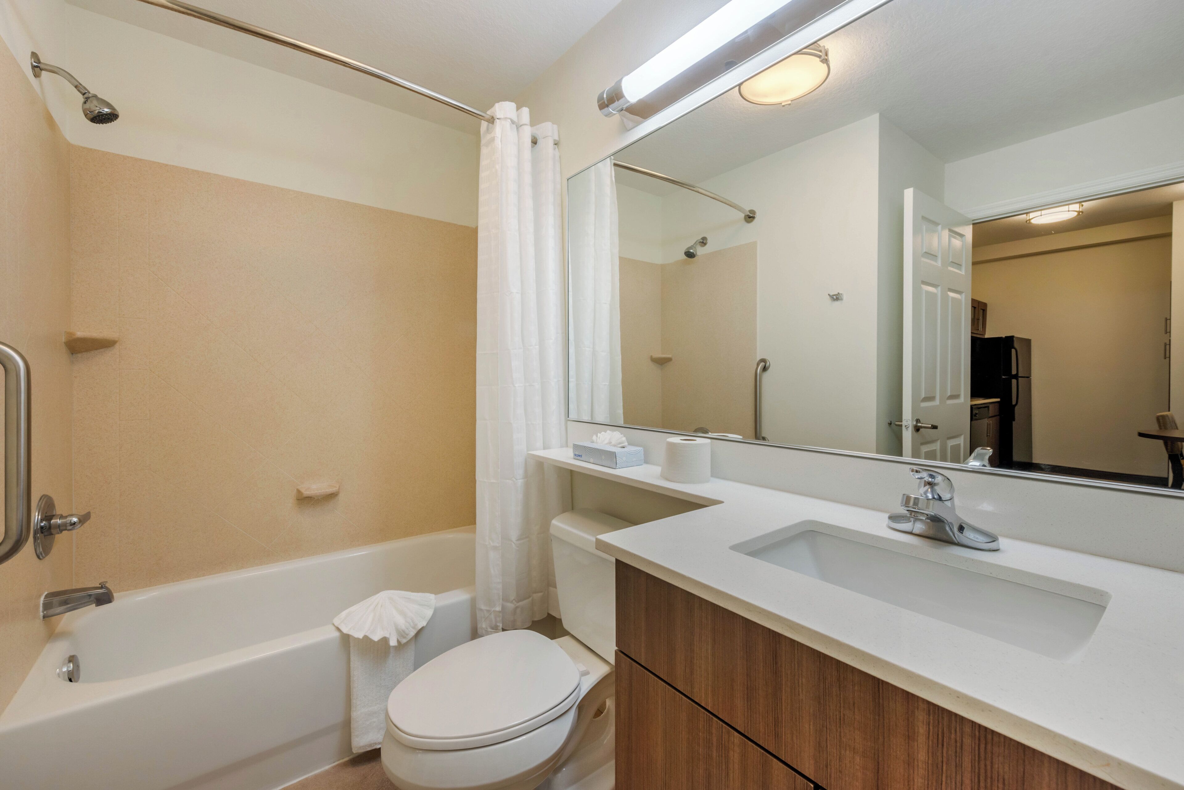 A bathroom with a bathtub, toilet, and sink.
