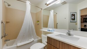 A bathroom with a bathtub, toilet, and sink. - Candlewood Suites Fort Myers Sanibel Gateway by IHG (Fort Myers)