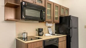 A compact kitchen with a microwave, coffee maker, and a dishwasher. - Candlewood Suites Fort Myers Sanibel Gateway by IHG (Fort Myers)