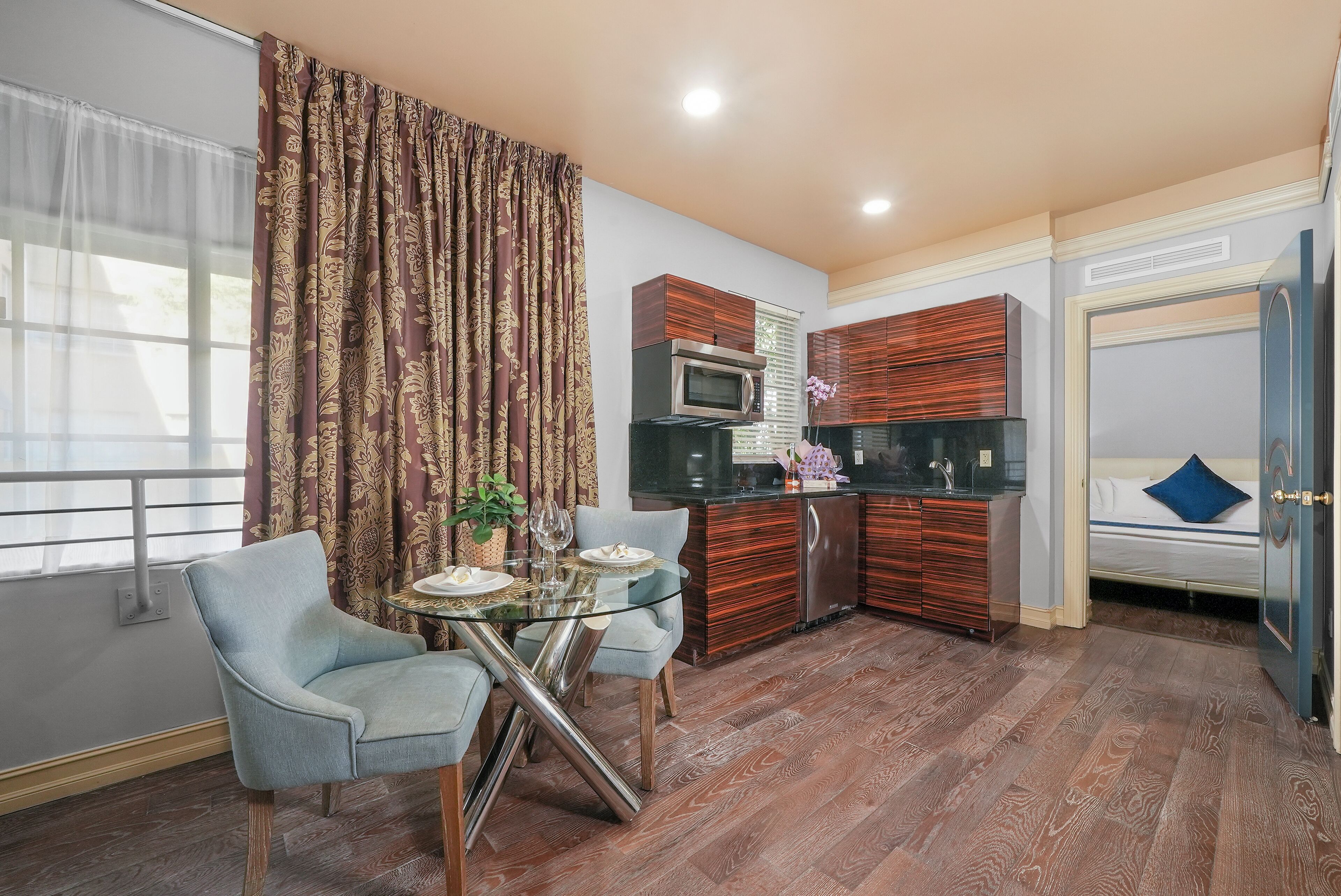 A compact living space with a dining area, kitchenette, and a bed.