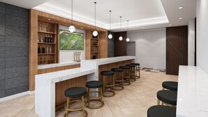 A modern bar area with a marble countertop, wooden shelves, and black bar stools. - Staybridge Suites Williamsville Buffalo by IHG (Buffalo)