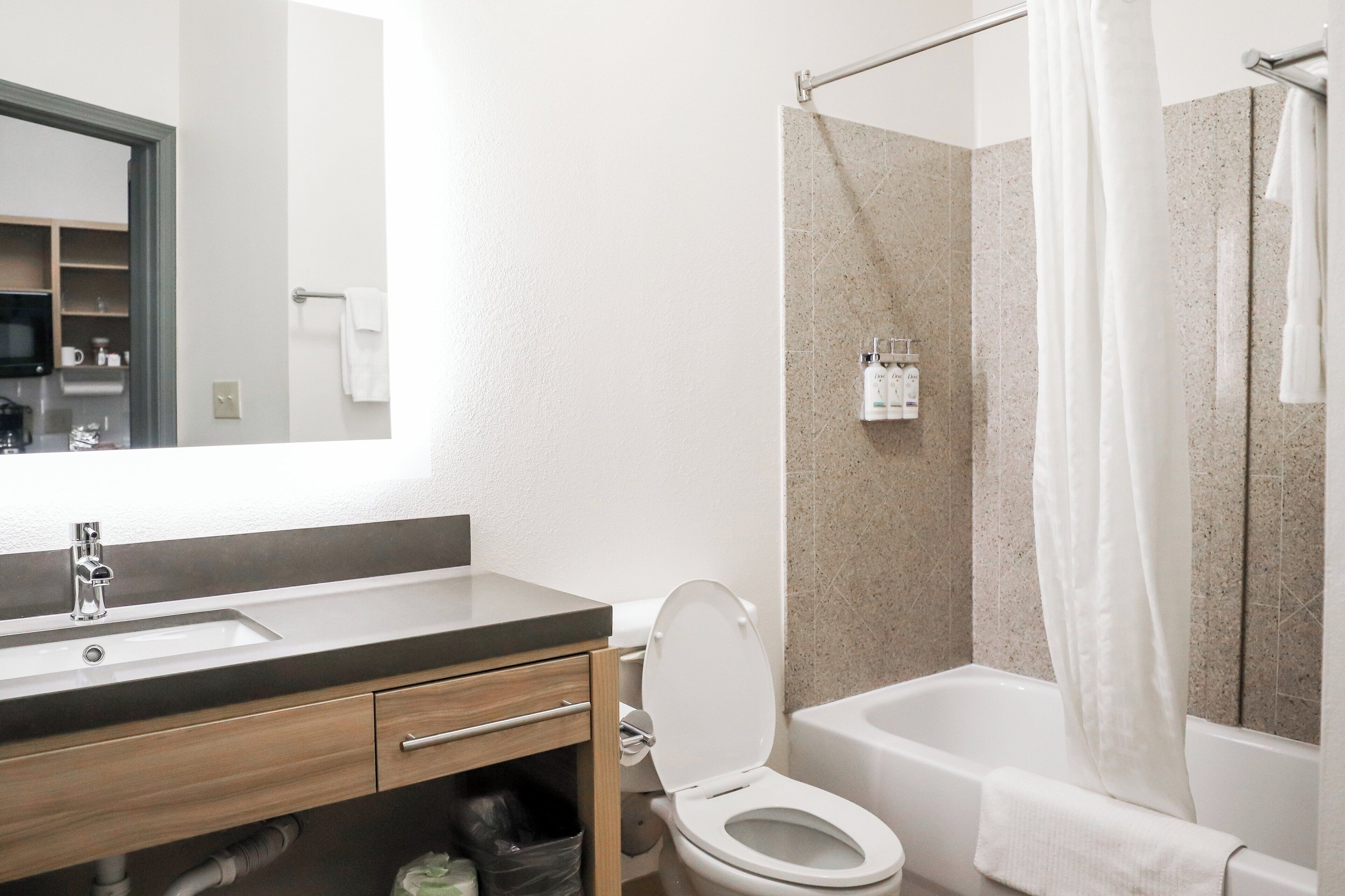 A bathroom with a sink, toilet, and bathtub.