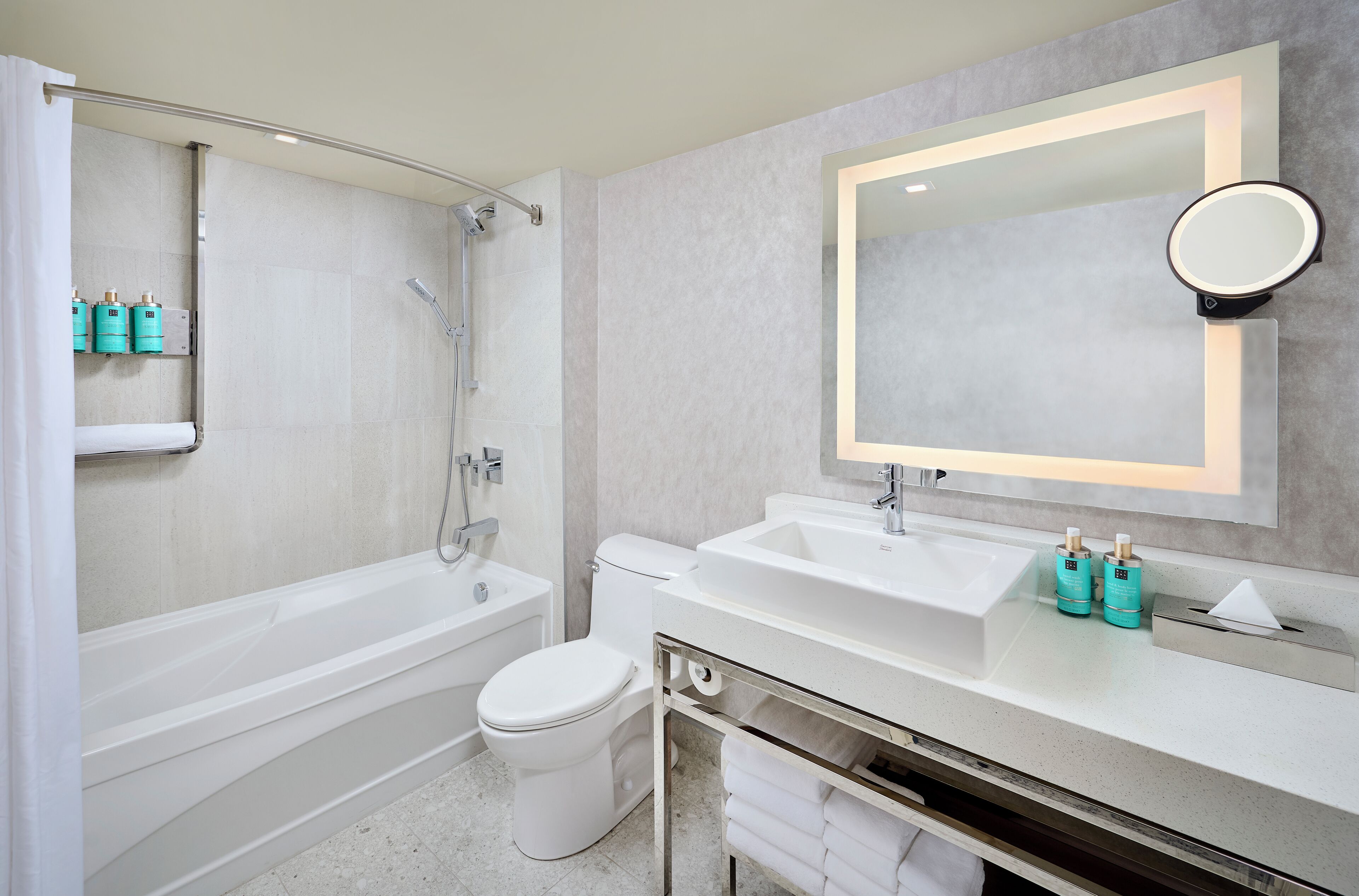 A modern bathroom with a bathtub, toilet, and sink.