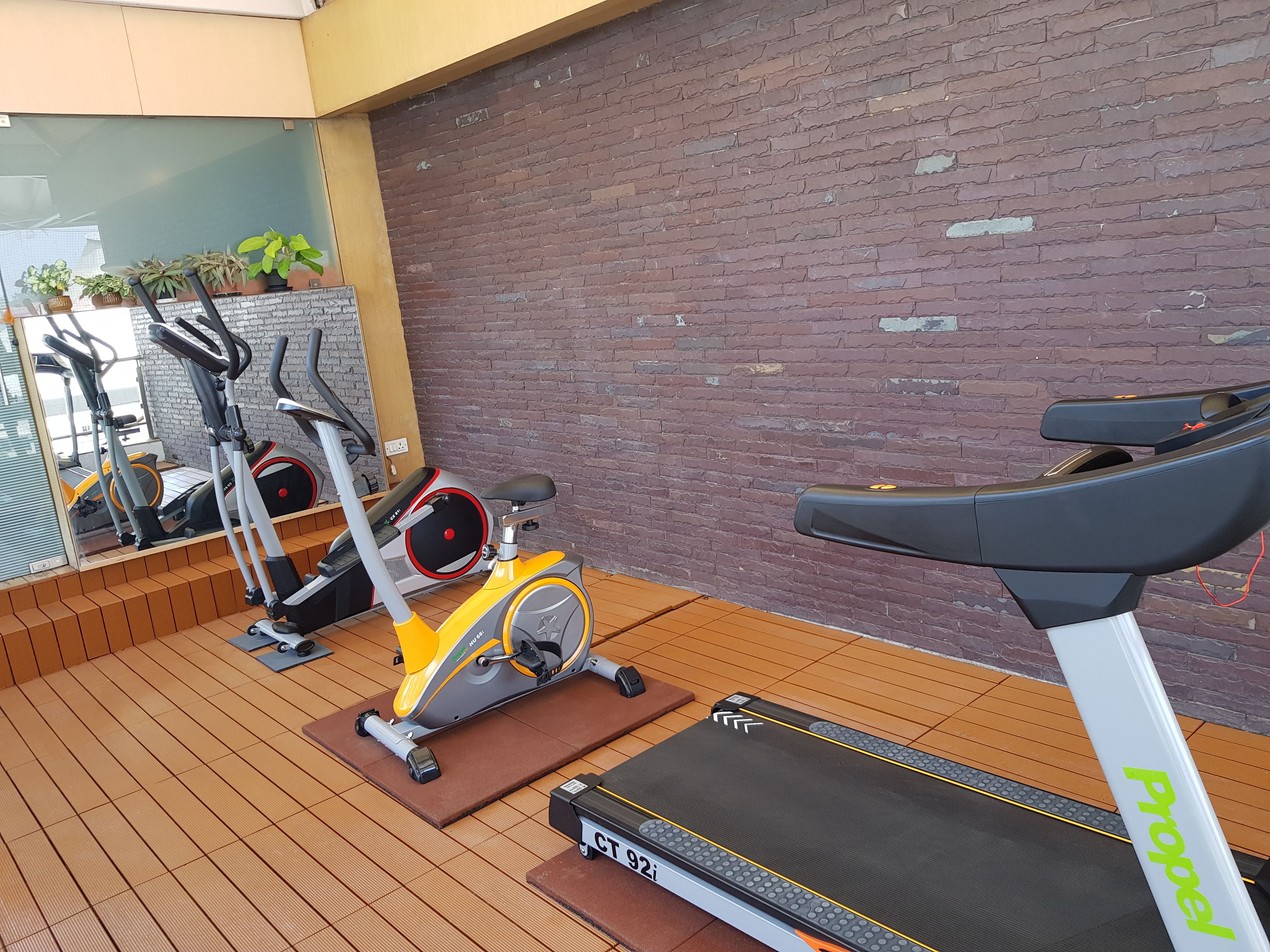 A gym with stationary bikes, a treadmill, and a Propel brand treadmill.
