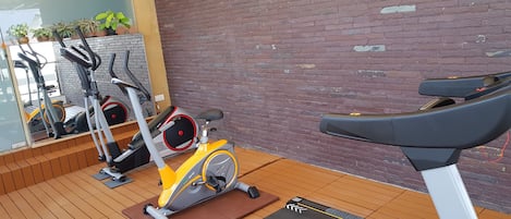 A gym with stationary bikes, a treadmill, and a Propel brand treadmill.