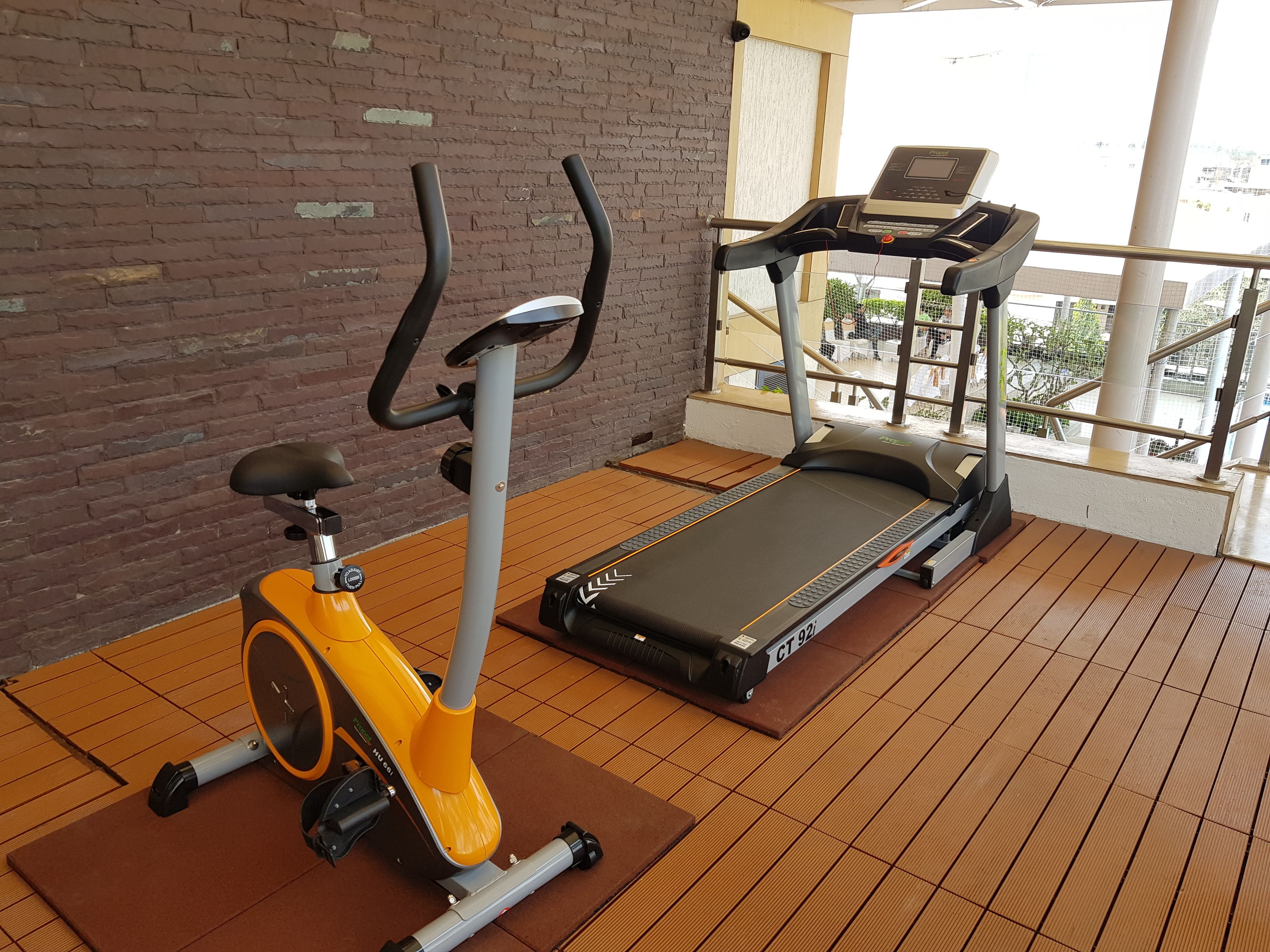 An indoor gym with a stationary bike and a treadmill.