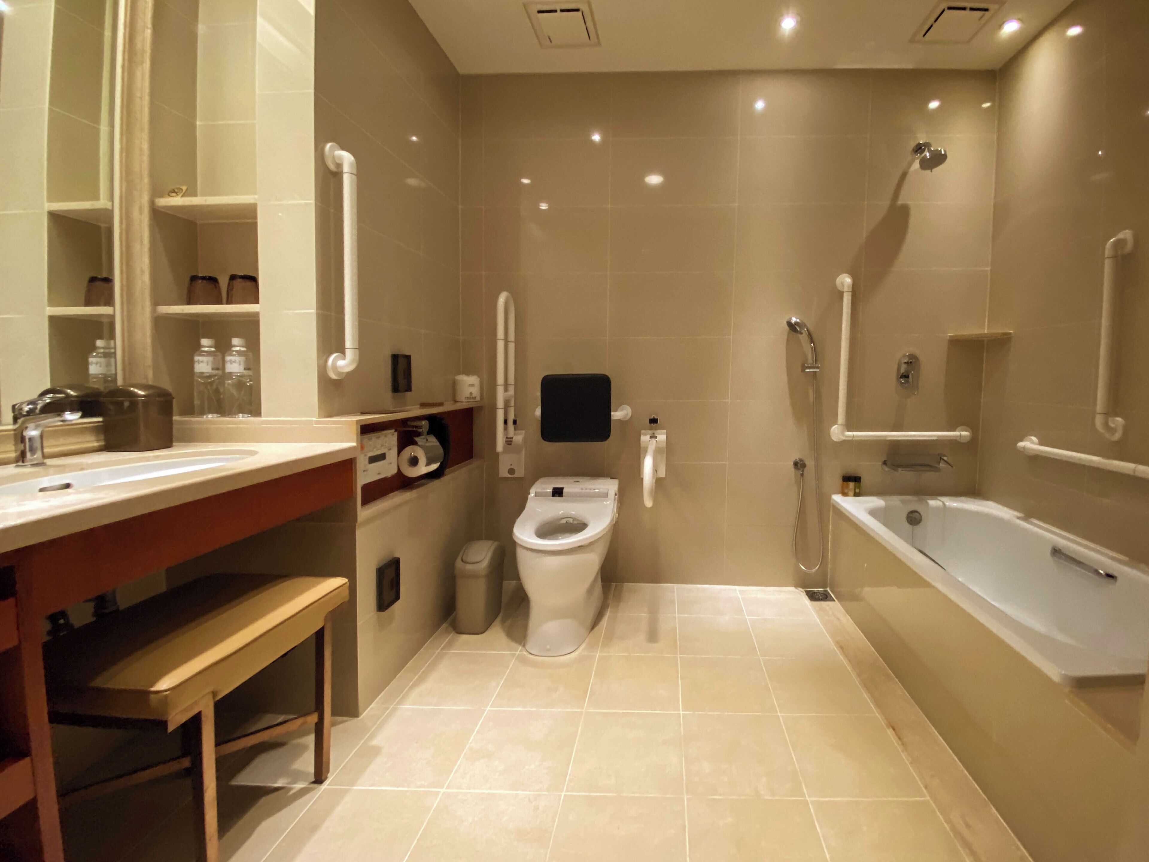 A modern bathroom with a toilet, sink, and bathtub.