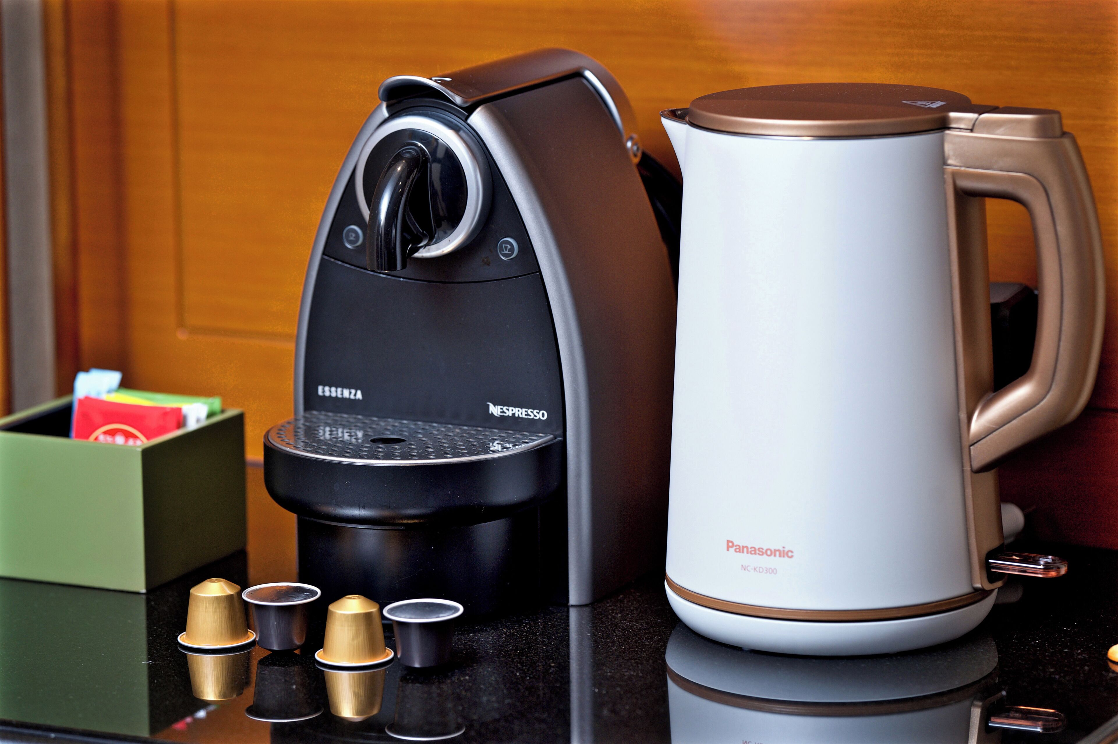 A coffee maker and a kettle on a countertop.