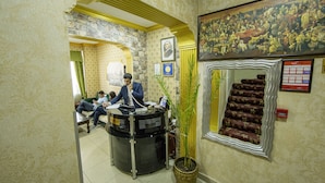 A lobby with a reception desk, a staircase with a decorative mirror, and a large historical painting on the wall. - Meddusa Hotel (Istanbul)