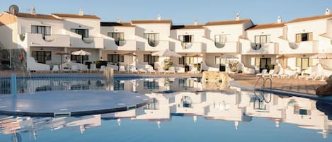 Seasonal outdoor pool, open 9:00 AM to 7:00 PM, pool umbrellas