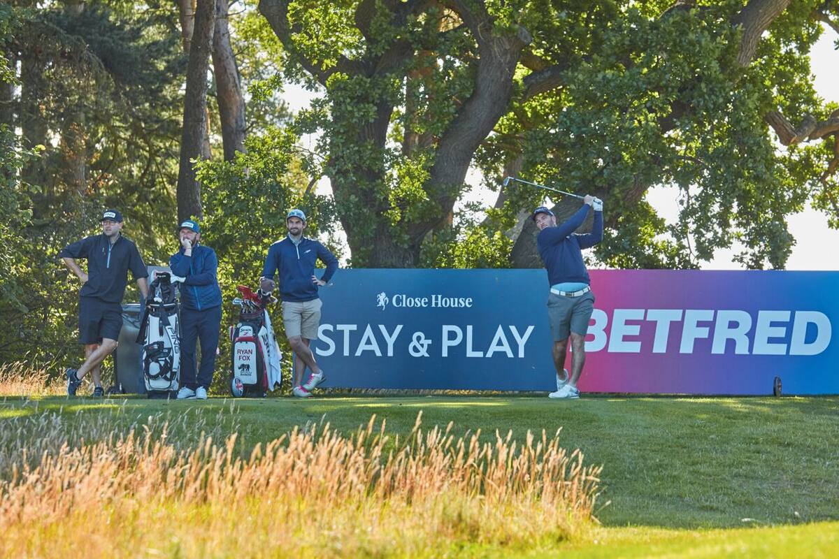 A golf course with a 'Close House' sign and 'STAY & PLAY' banner.