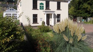 A two-story building with a sign indicating it is a guest accommodation. - Deanfield Bed and Breakfast (Lydney)