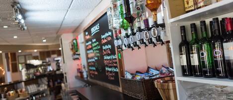 A bar area with shelves of liquor bottles and glasses.