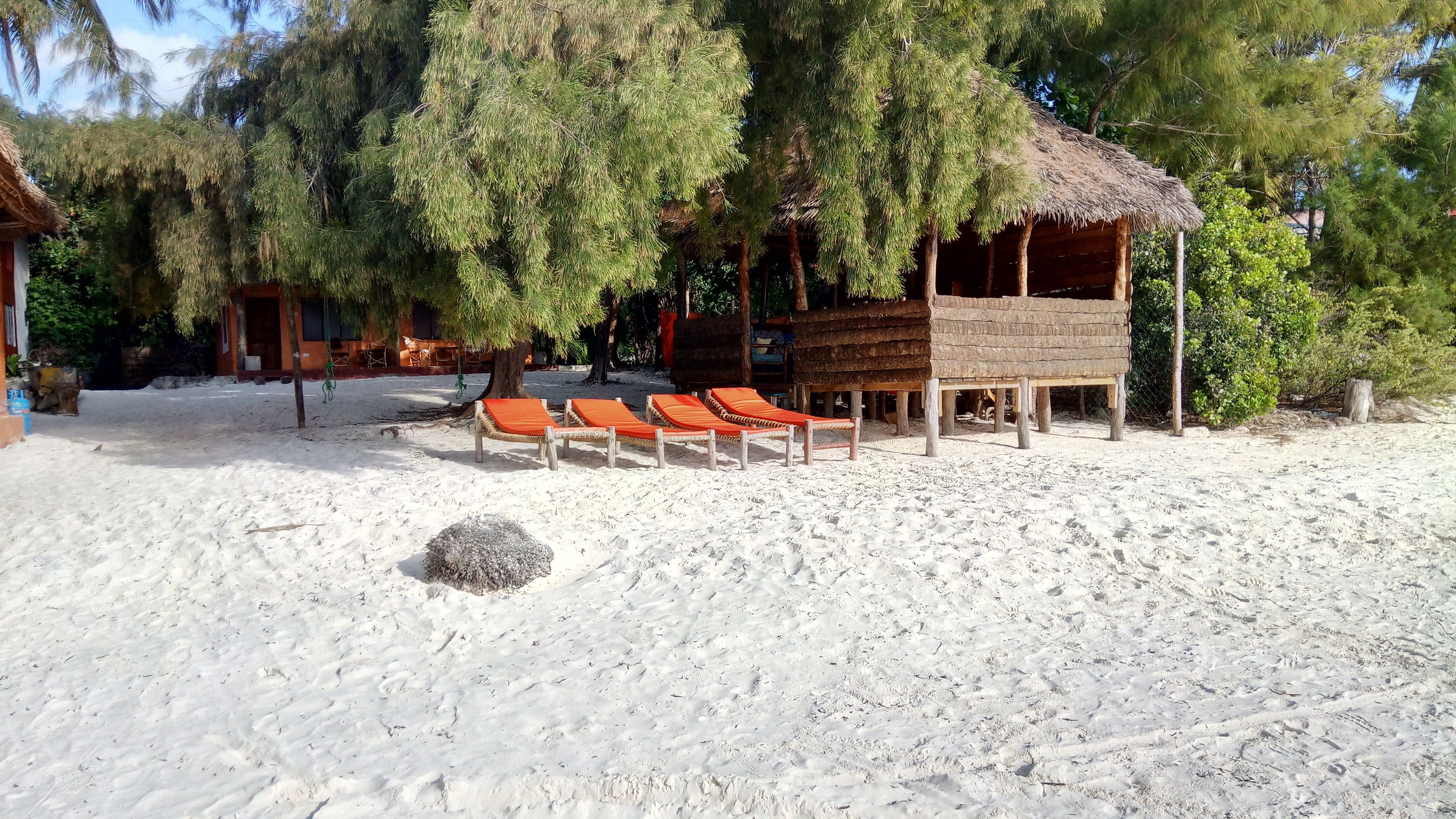 On the beach, white sand, sun-loungers, beach towels