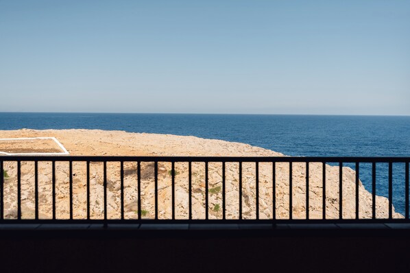 A coastal view with a sandy beach and the sea.