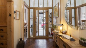 A wooden interior with a desk, a mirror, and a door leading outside. - Melrose Guest House (Ambleside)