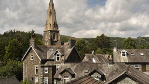 A historic building with a prominent tower and multiple gabled roofs. - Melrose Guest House (Ambleside)