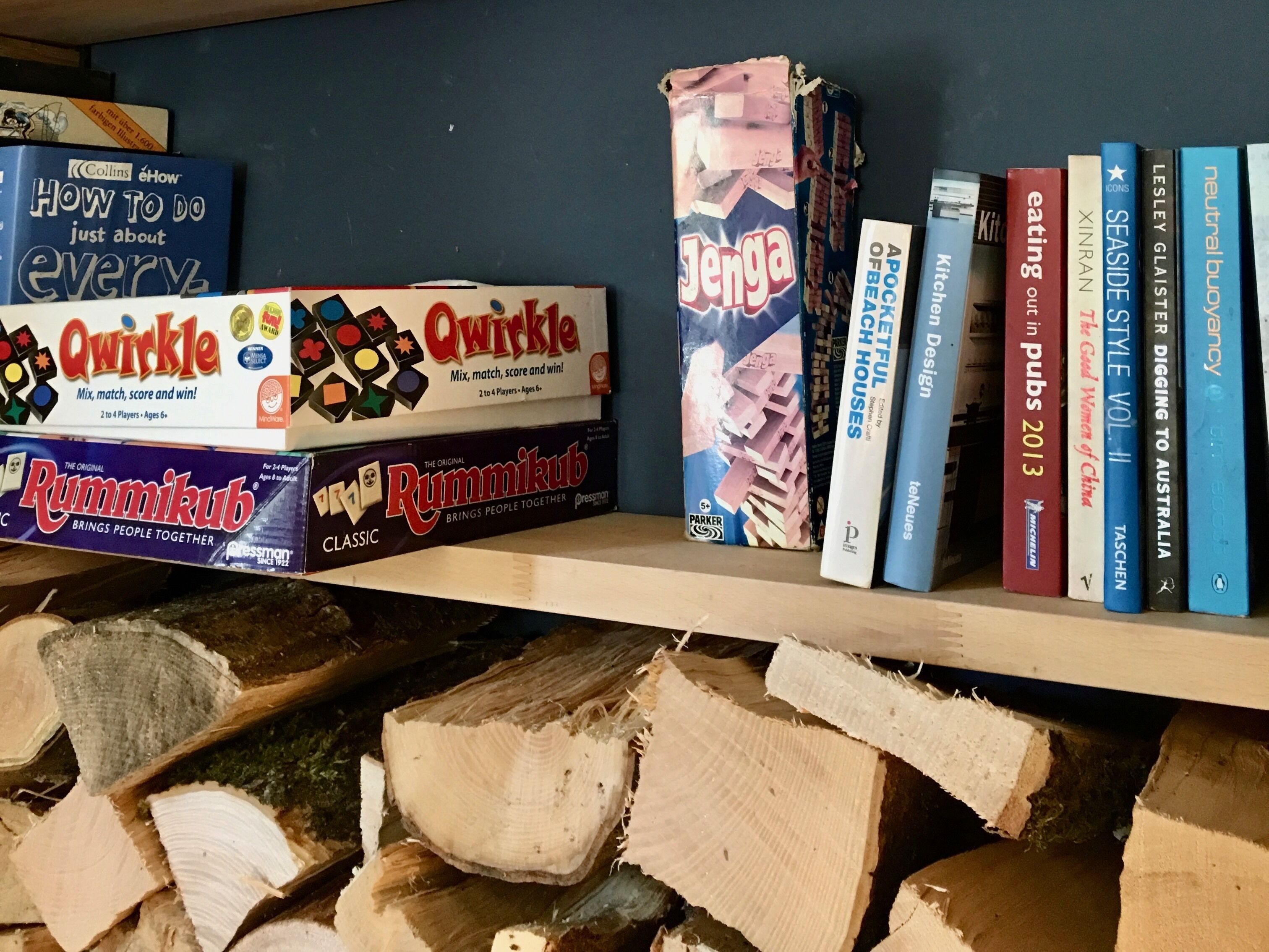 A shelf with board games and books.