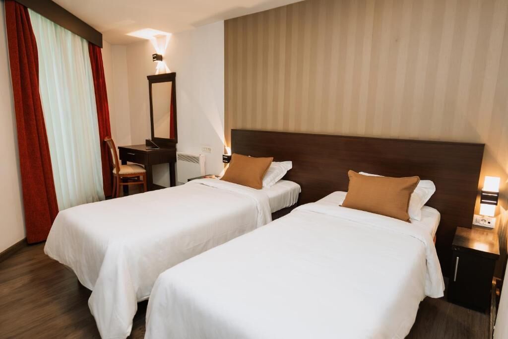 Classic Twin Room | Minibar, in-room safe, desk, blackout drapes