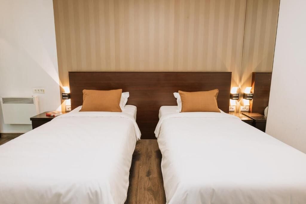 Classic Twin Room | Minibar, in-room safe, desk, blackout curtains