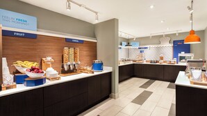A modern breakfast area with labeled sections for fruit, cereal, and bakery.