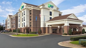 A Holiday Inn Express hotel with a two-story structure, a covered entrance, and a parking lot.