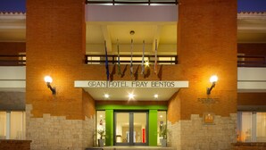 The entrance of Gran Hotel Fray Bentos with a brick facade, green accents, and a sign above the doors. - Gran Hotel Fray Bentos (Fray Bentos)